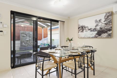 Enjoy group meals at our stylish 6-seater glass dining table, offering a seamless indoor-outdoor transition right out to the private, peaceful backyard courtyard.