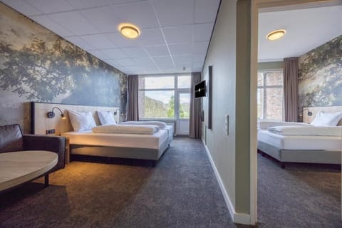 Unwind in a spacious room with calming forest-inspired walls.