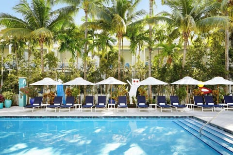 Stretch out on loungers in a playful, tropical pool courtyard.