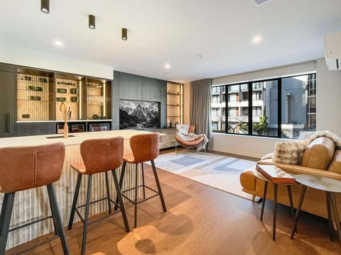 Designer open-plan living with a gourmet kitchen, premium finishes, and a warm, inviting atmosphere.