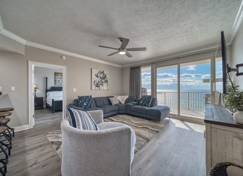 Step into your serene living space with breathtaking ocean views, where plush seating invites you to relax and soak in the coastal beauty through expansive glass doors.
