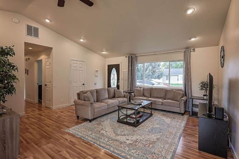 Cozy living room with sofas, TV, and large window for natural light