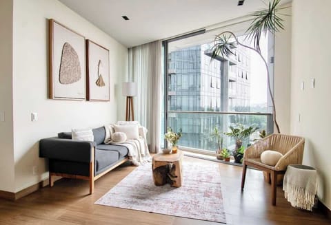 Large windows fill the space with city views and natural brightness, bringing the energy of Polanco right into your living room.
