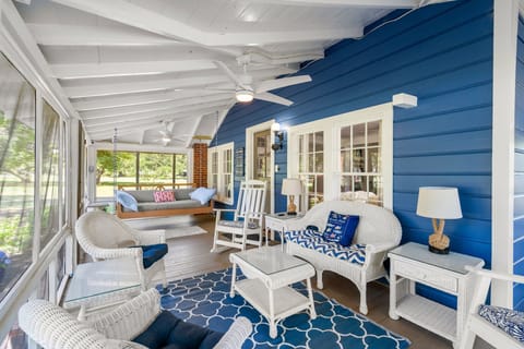 A charming wraparound porch—plenty of seating, peaceful surroundings, and the perfect spot to relax and enjoy the quiet.