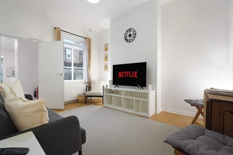 The bright and welcoming lounge is equipped with a sofa, a chair, free Wi-Fi, a Smart TV, and a convertible dining table, creating a comfortable space to unwind or dine.