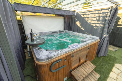 Private covered hot tub with privacy curtains for a relaxing spa escape