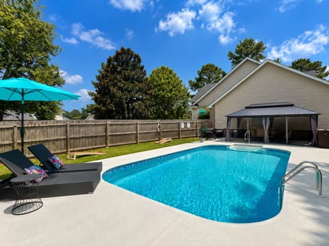 In-ground Pool w/Covered Dining Area, corn hole, & lounge chairs