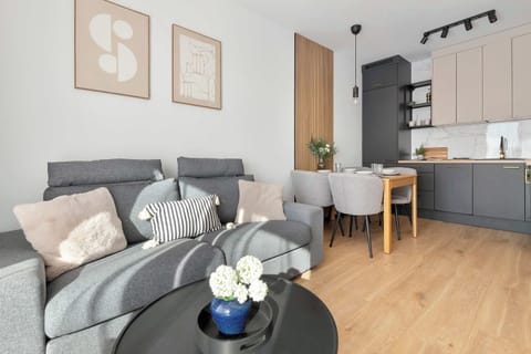 A cozy open-plan living space with a sofa and dining area. Enjoy quality time with your family or friends in a welcoming atmosphere.