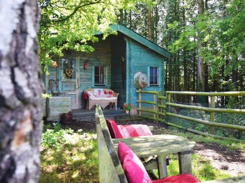 A charming log cabin tucked away under the trees