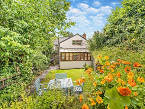 A charming cottage nestled within an established garden