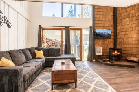 Comfy sectional sofa, real wood coffee table with cubbies, fireplace & smart TV.