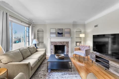 Relax and unwind in the inviting main living room, featuring comfortable seating, a 65" Smart TV and plenty of space to gather after a day exploring Omaha.