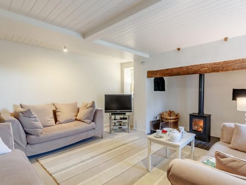 Relax by the cosy wood burner in the lounge