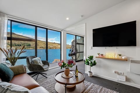 Living Room: Unwind in comfort while soaking up breathtaking lake views from this beautifully designed space, made for relaxing moments and memorable stays.