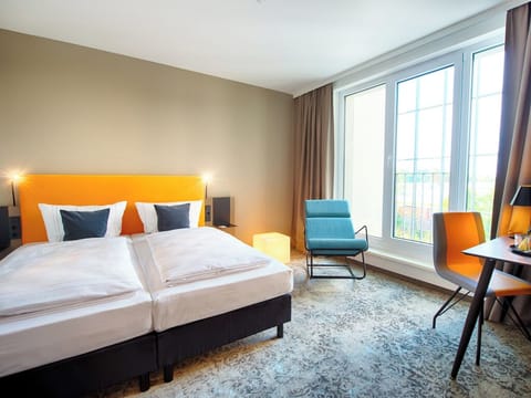 Step into a sunlit retreat with twin beds and views.
