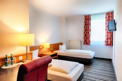 Unwind after adventures in a bright, simple twin room.