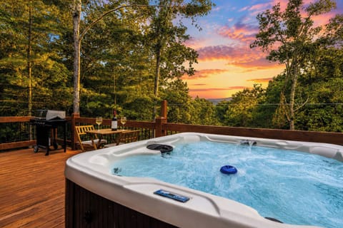 Hot tub with mountain views and a sunset