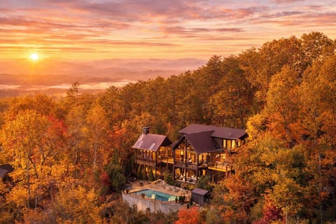 Wake before the valley does. From this ridge, first light spills gold across layer after layer of Blue Ridge — and the whole scene, heated pool included, belongs to your group alone.