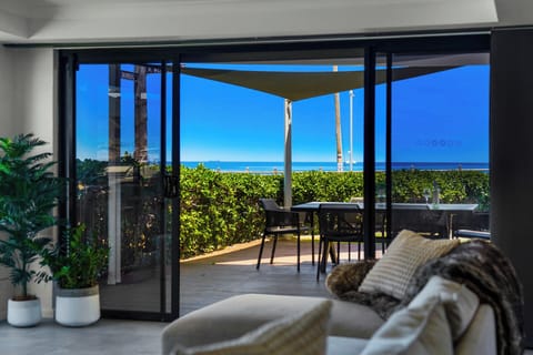 Seamless indoor–outdoor living with ocean views from the kitchen.