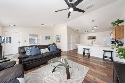 Bright open living room with fully equipped kitchen and breakfast bar