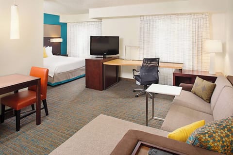 Unwind in a spacious suite with sofa, desk, and TV.