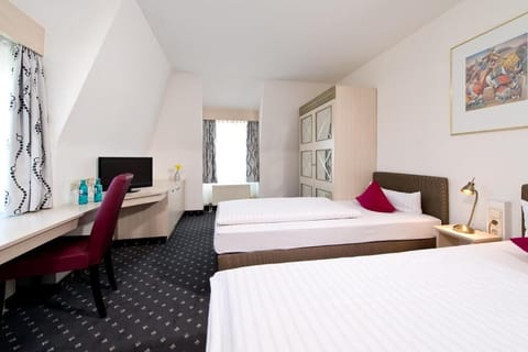 Settle in with roomy layout, desk nook, and twin beds.