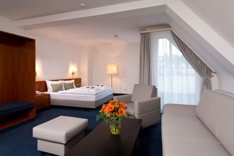 Stretch out in a spacious suite with lounge seating and sunlight.