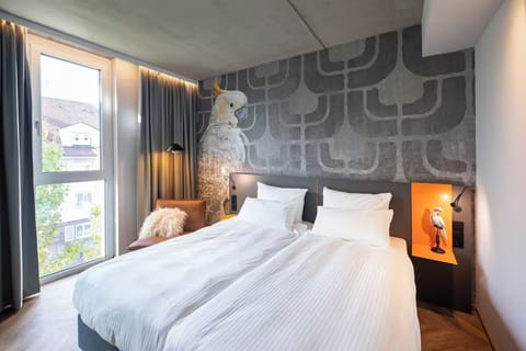 Wake up refreshed in crisp linens beside sunlit windows.