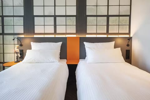Unwind in crisp twin beds beneath softly glowing headboard lights.