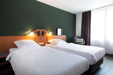 Stretch out on twin beds in a calm, modern room.