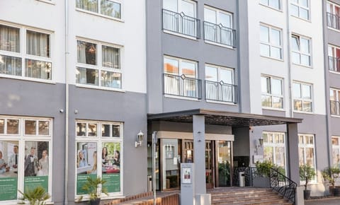 Stroll through green paths to sunny outdoor terrace seating.
