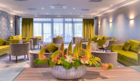 Settle into plush seating and unwind in a sunlit lounge.