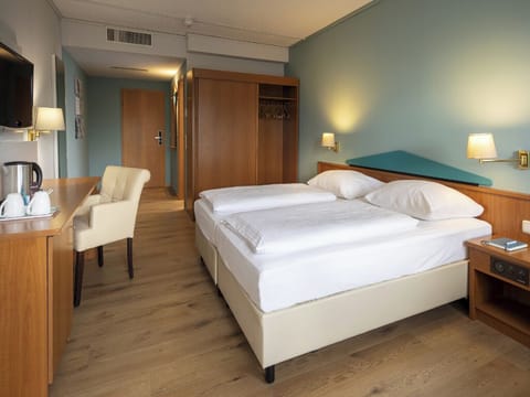 Settle in effortlessly with generous space and warm bedside lighting.