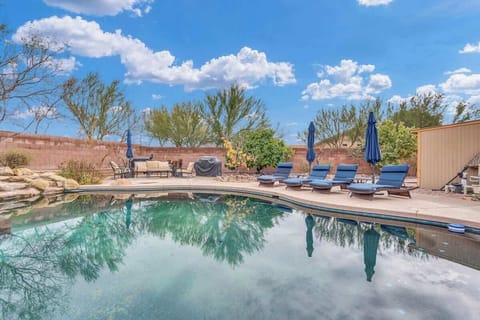 Pool with lounge chairs and BBQ.