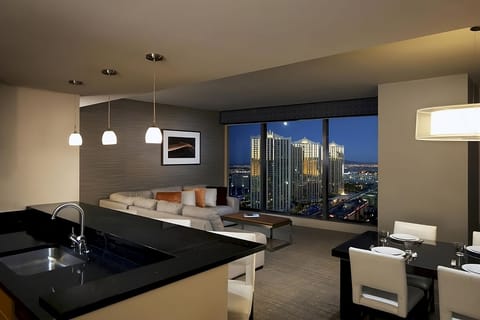 Sip cocktails by panoramic windows as city lights glow.