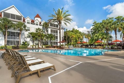 Soak up sunshine beside the resort pool and swaying palms.
