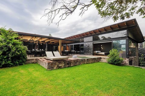 Wraparound glass walls and a jacuzzi deck with beautiful backyard