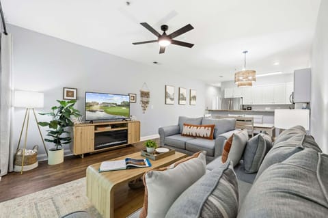 Guests can gather in the bright living space to stream a game on the flat-screen TV after a morning on the golf course.