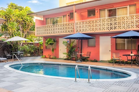 Sip something cool under umbrellas beside the refreshing pool.