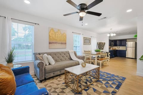 Bright modern living space in Dallas featuring large windows and blue decor