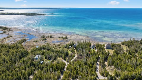 Crystal-clear waters and rugged Lake Huron shoreline surrounding Changing Shores.