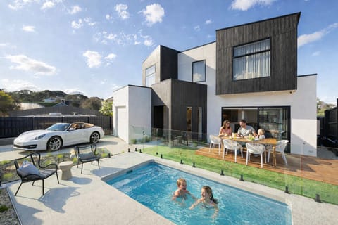 Modern luxury home with private pool and stylish outdoor dining