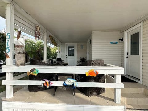 Covered patio with seating: Relax with your morning coffee surrounded by palm trees and coastal breezes.