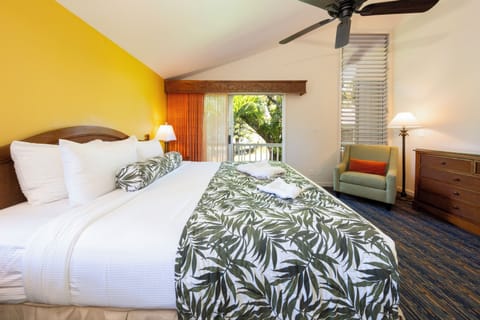 Unwind into crisp linens with lush balcony views.