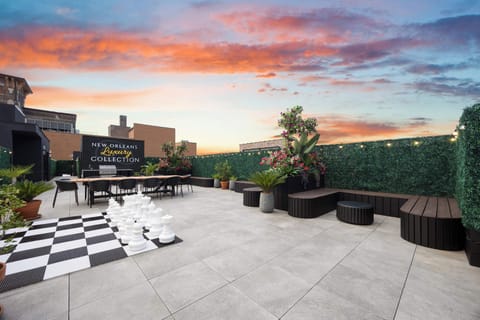 The spacious rooftop is designed for groups, with dining tables, lounge seating, oversized chess and plenty of room to gather.