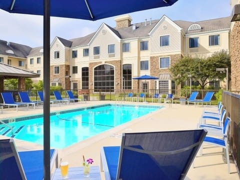 Unwind poolside on bright loungers under sunny umbrellas.