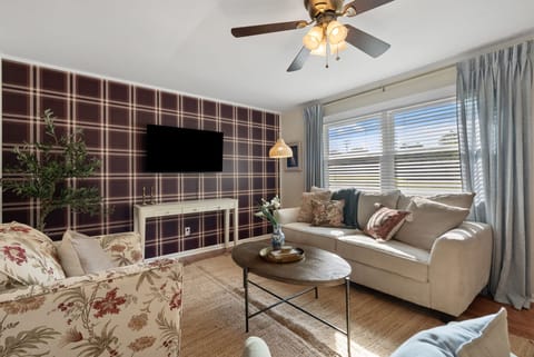Welcome to our home! Our comfortable living room (semi open floor plan; it's separated by a half wall to the kitchen & dining table) seats 5+ guests and has a TV and family games.