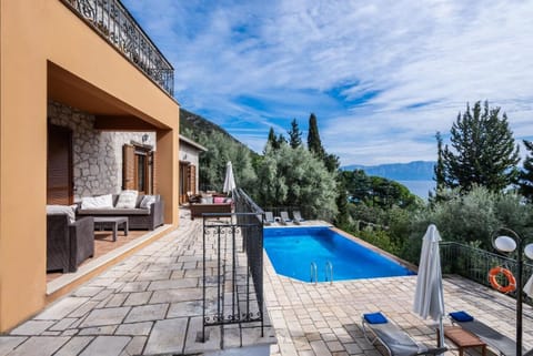 Villa patio with outdoor lounge seating and a private swimming pool.