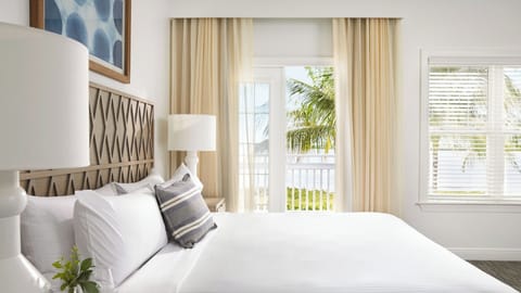 Wake up to soft light and balcony breezes beyond.