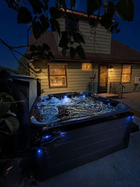 Private patio hot tub with cozy evening lighting for relaxing nights